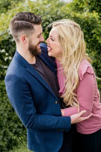 engaged couple laugh and hug