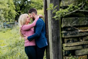 couple hugging and leaning on dry-stone wall