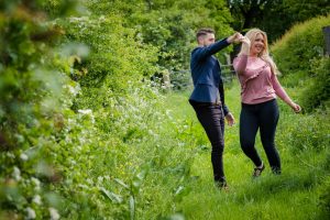 man and woman dance on grass
