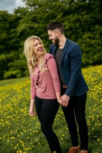 woman looking over shoulder at man laughing