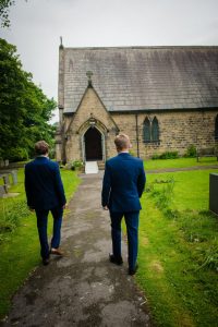 groom and best man walking to church