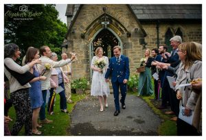 bride and groom leave church confetti throwing.