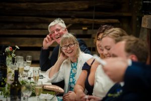 bride's parents laugh during speeches