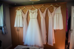 wedding dress and bridesmaids dresses hung up