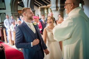 bride and groom laugh during the wedding ceremony