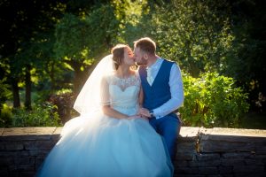 newlyweds kissing in evening sunlight
