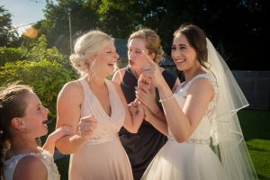 bride and bridesmaids laughing and pointing