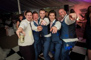 groomsmen dancing and singing with groom