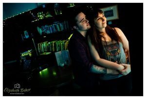 cuddling couple in light from doorway