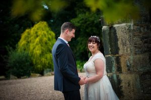 laughing bride and groom lookg at camera
