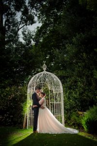new mr and mrs in birdcage with lighting