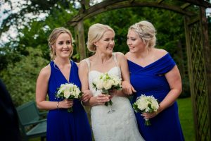 bride and sisters cuddle up and laugh