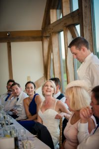 bride looks at groom during speeches