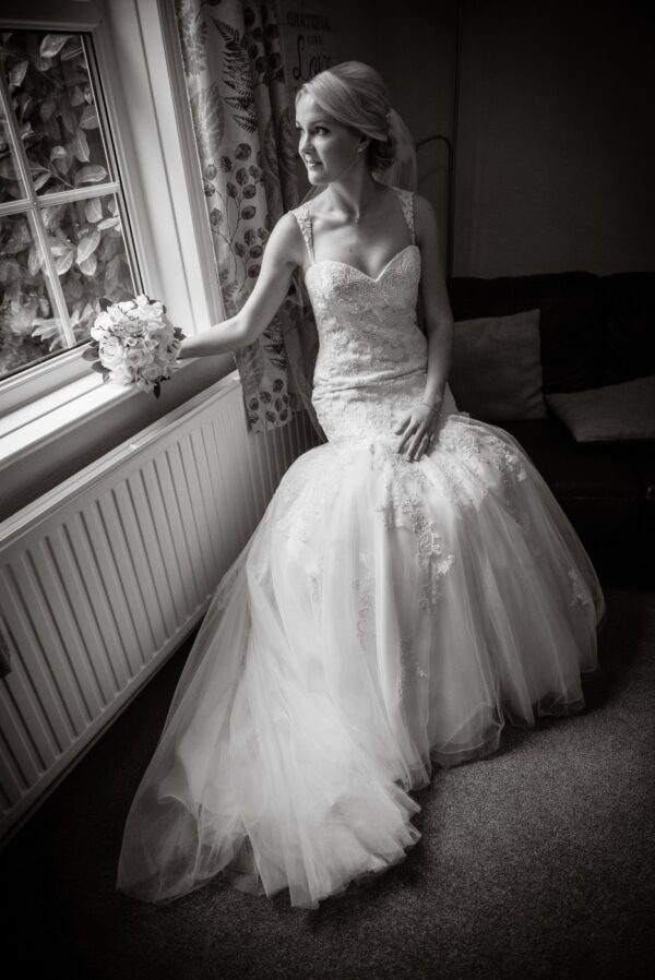 Bride seated black and white