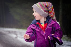 child plays in the snow