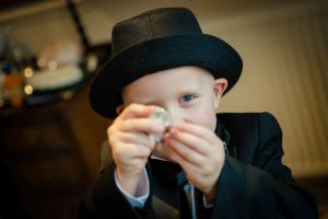 little boy holds up watch to camera