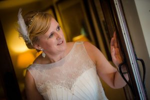 bride peeps out from the door