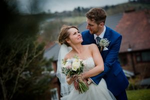 Bride and groom looking at each other at the white hart lydgate