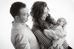 black and white portrait of parents and newborn
