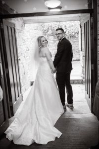black and white of couple leaving the venue