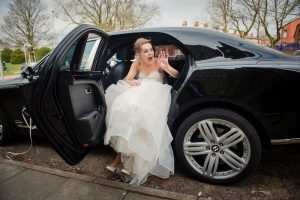 bride waves at guests