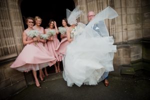 brides face is obscured by the veil in the wind