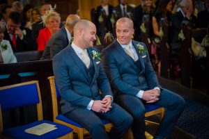 groom and best man seated waiting for bride
