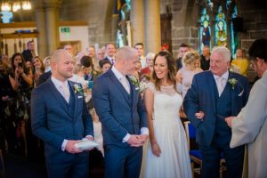bride and groom smile at each other