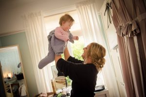 sister lifts baby