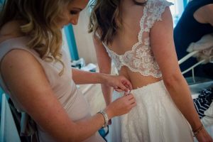 bride's sister helps to get ready