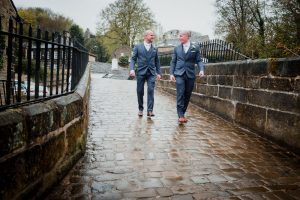 groom and best man walking from the pub