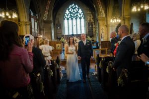 newlyweds exit the church down the aisle