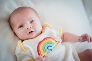 baby wearing rainbow vest