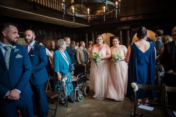 bridesmaids walk down the aisle