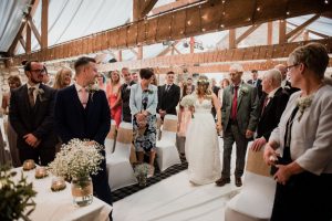 Bride walks down the aisle at The Old Barn Esholt