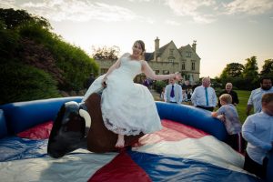 bride rides the bucking bronco outside bagden hall