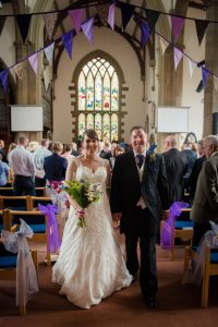 couple walk down the aisle