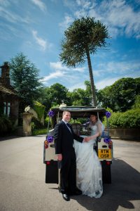 bride and groom in wedding land rover