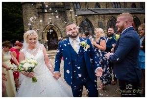 Confetti is thrown at the bride and groom