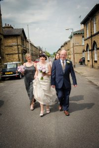 bride and bridesmaids walk to the venue