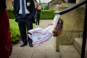 little girl swings on a railing