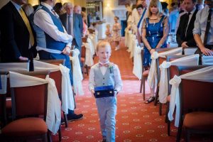 ring bearer walks down the aisle