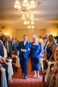 groom and mum walk to get married