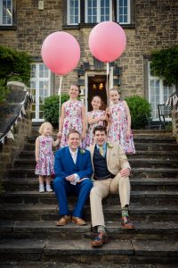 grooms sitting with bridesmaids portrait