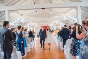 newly married couple walk out of ceremony