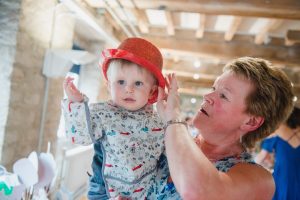 little boy plays with hat