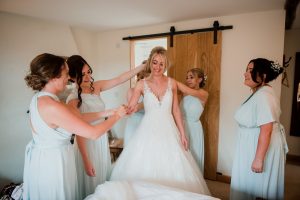 bridesmaids help get the bride ready