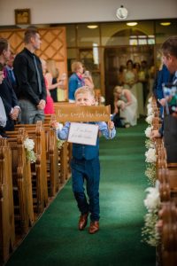 little boy holds up sign