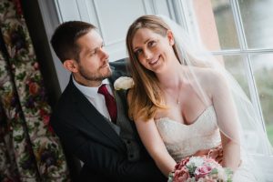 bride looking at camera and groom looking at bride