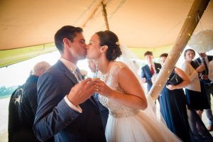 bride and groom kiss in tipi